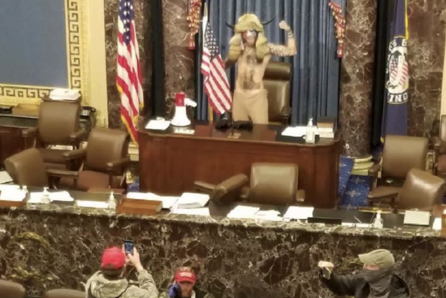 January 6 insurrectionist Jacob Chansley in the U.S. Senate chamber, in Senate president's seat from which he refused an order to leave.