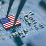 Flag of USA on a processor, CPU Central processing Unit or GPU microchip on a motherboard. Congress passes the CHIPS Act of 2022 to strengthen domestic semiconductor manufacturing, research and design.