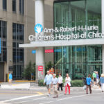 People walk by Ann and Robert H Lurie Children's Hospital of Chicago.