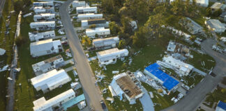 Severely damaged by hurricane Ian houses in Florida mobile home residential area. Consequences of natural disaster.
