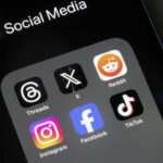 Portland, OR, USA - Oct 26, 2023: Assorted social media apps, including Threads, X, Reddit, Instagram, Facebook, and TikTok, are seen on an iPhone.