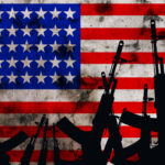 Several automatic rifles raised up on the background of the American flag. High quality photo