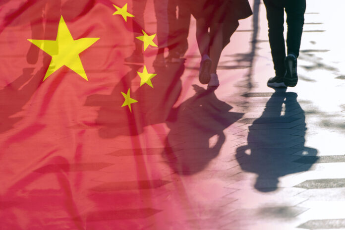 Shadows of People on the road and Flag of China concept picture